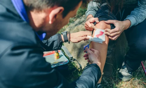 man-bandaging-the-injured-knee-of-a-woman-2026-03-25-00-29-53-utc